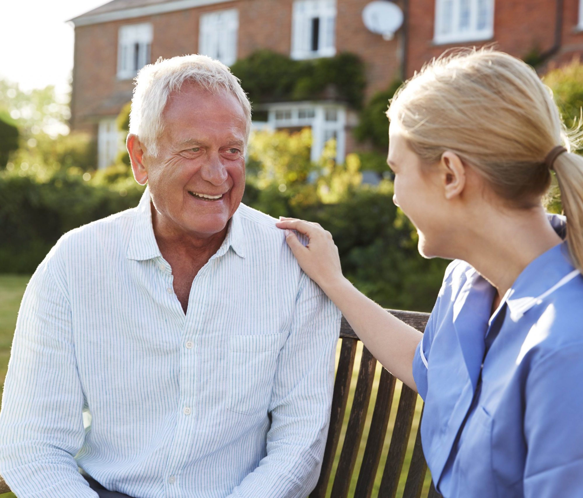 Nurse Talking To Senior Man In Residential Care Home